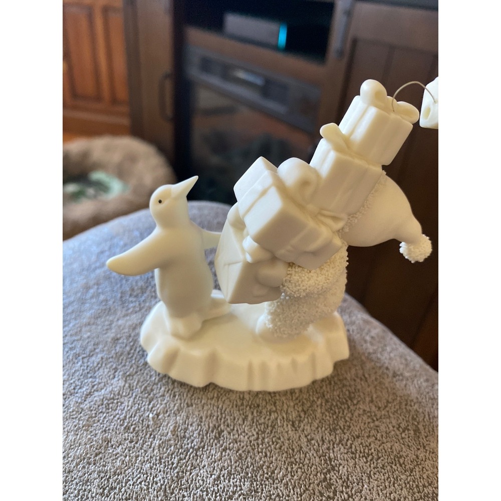 Department 56 Snowbabies porcelain figurine featuring a child carrying gifts